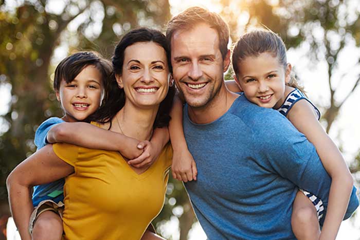 Family of four smiling